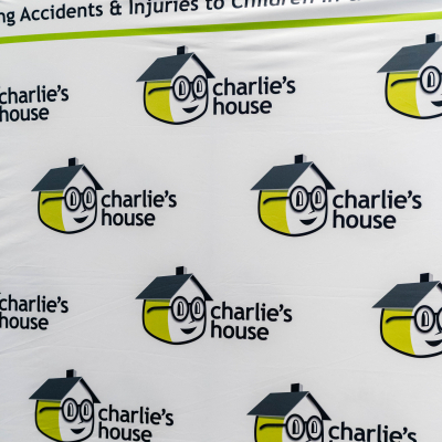 Charlie's House step-and-repeat banner reading Preventing Accidents & Injuries to Children In & Around the Home
