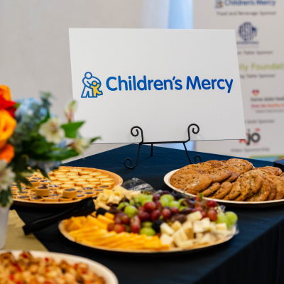 Snack platters and flowers on a table with a Children's Mercy sign