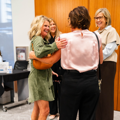 Guests greeting each other with hugs at the reception