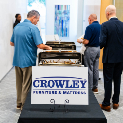 Guests serving themselves at the buffet sponsored by Crowley Furniture & Mattress