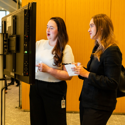 Two young women exploring the touchscreen safety display