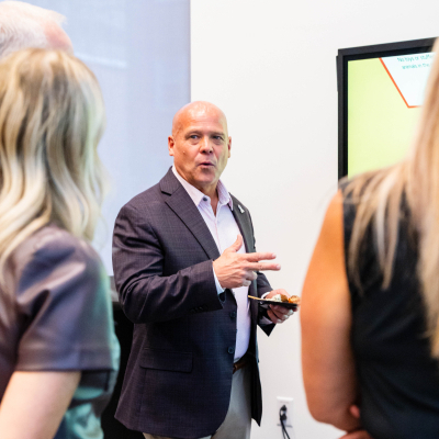 Man in a dark blazer gesturing while describing the interactive safety experience