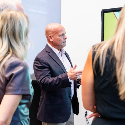 Man in a dark blazer explaining the safety display to guests