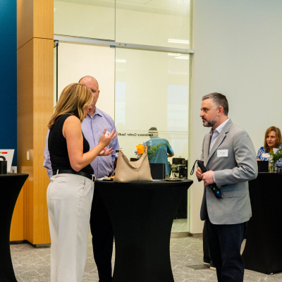 Guests chatting around cocktail tables in the venue