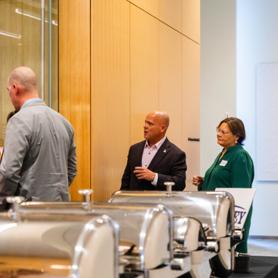 Guests standing near the buffet table during the reception
