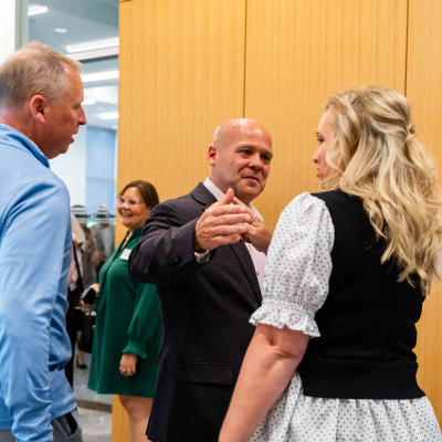 Guests greeting one another with a handshake at the reception