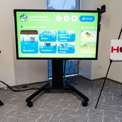 Charlie's House Virtual Safety Experience displayed on a screen next to a HOTS sign