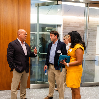 Three guests in conversation in the lobby of the event venue