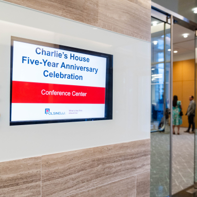 Lobby screen announcing the Charlie's House Five-Year Anniversary Celebration in the Conference Center