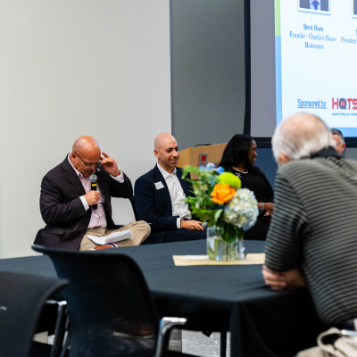 Guests at a table watching the panel discussion