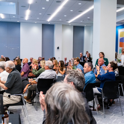 Audience clapping throughout the event room at the 5 year anniversary celebration
