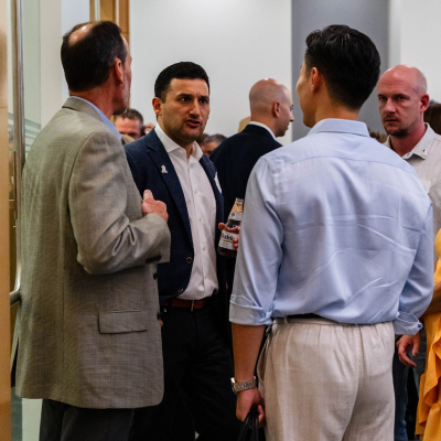 Group of men chatting near the entrance of the event room