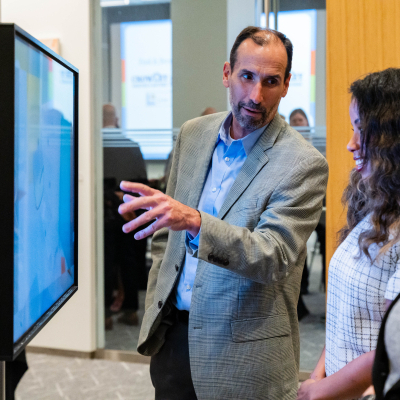 Man gesturing toward the safety display as he explains it to guests