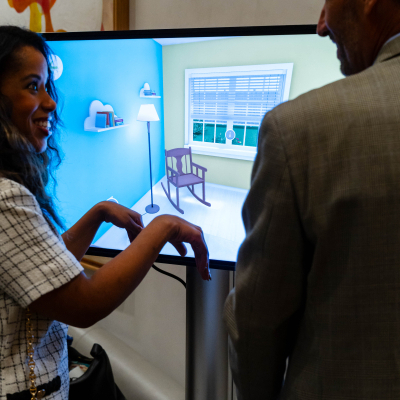 Woman smiling while using the interactive safety touchscreen with a man beside her
