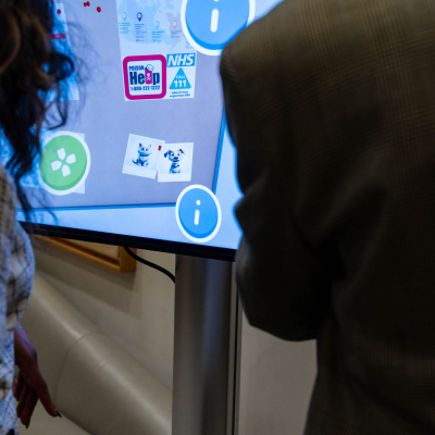 Guests viewing safety information on the interactive Charlie's House touchscreen