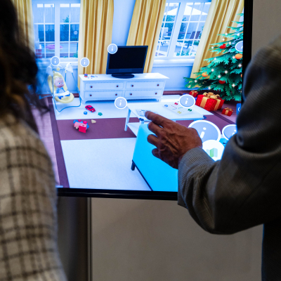 Guest pointing to a hazard in a virtual holiday living room on the safety display