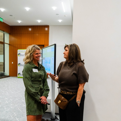 Two women chatting near the interactive safety display
