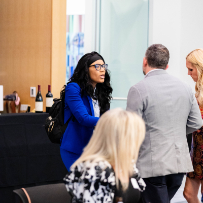 Guests mingling and seated at tables during the anniversary reception