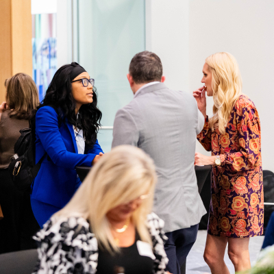 Groups of guests standing and talking during the reception