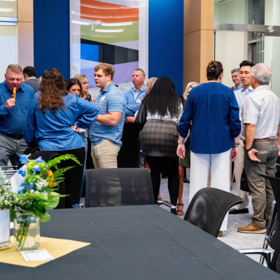 Crowd of guests mingling in the event room during the reception